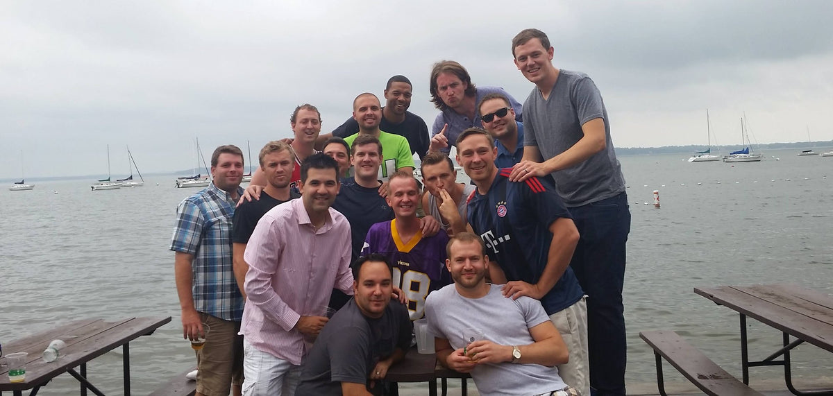 The old group of friends together at a lakeside pier