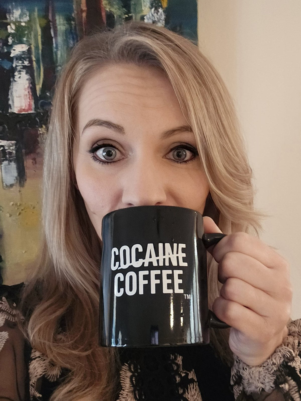 Yulia drinking from a Cocaine Coffee mug